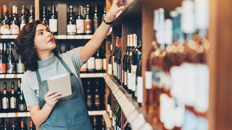 Busy young woman in the wine shop FG Knights Liquor Merchandiser 2025